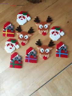 christmas decorations made out of legos on a wooden floor with santa clause and reindeer