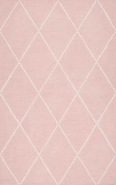 a pink rug with white diamonds on it