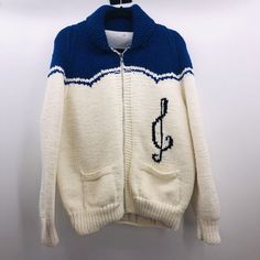 This Awesome Vintage Handmade Sweater With A Square Dance Theme Is Perfect For Any Hoedown Or Rockabilly Music Event. It Features A Treble Clef On The Left Front Panel And A Dancing Couple On The Back. The Chunky-Knit Blue And White Wool Sweater Features A Shawl Collar And Long Sleeves With A Full Zip And Pockets. It Is A Size 42-44 And Is Suitable For Men Or Women. It Measures Approximately 23.5" From Armpit To Armpit And 26" From Shoulder To Bottom. The Sweater Is Made Of Wool And Should Be Hand Washed Only. It Has A Lined Interior And Is In Great Shape Despite Being Pre-Owned. Photos Show The Lining Stitching Coming Loose Along The Bottom But This Can Be Easily Repaired. This Cozy Sweate Vintage Blue Cotton Cardigan, Retro Blue Cardigan For Winter, Fitted Retro Blue Cardigan, White Retro Winter Cardigan, Vintage Blue Knitted Cardigan, Vintage Blue Knit Cardigan, Retro White Knit Cardigan, Blue Vintage Knit Outerwear, White Knit Retro Cardigan