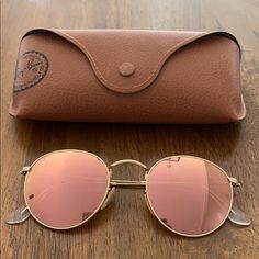 Brand New Rose Gold Ray-Ban Sunglasses. In Great Condition Except For One Tiny Speck On The Lens. Shown In Photos. Ladies Ray Ban Sunglasses, Pink Sunglasses With Mirrored Lenses And Round Frame, Pink Round Frame Sunglasses With Mirrored Lenses, Gold Rayban Sunglasses, Rose Gold Sunglasses With Gradient Lenses For Summer, Trendy Rose Gold Tinted Sunglasses, Pink Ray Bans, Pretty Sunglasses, Circle Glasses