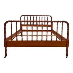 an antique wooden bed frame with wood slats