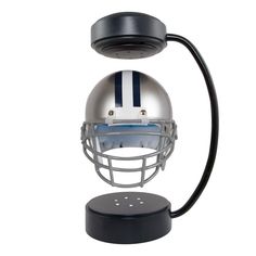 a football helmet on top of a black stand with a white and blue striped design