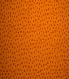 an orange background with small red stars on the top and bottom, all over it