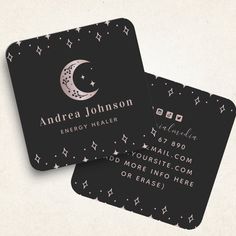 two black business cards with white stars and the moon