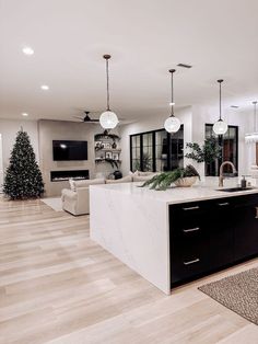 a kitchen with an island in the middle and christmas decorations on the counter top next to it