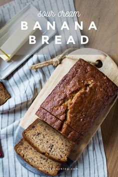 a loaf of banana bread sitting on top of a cutting board next to sliced bananas