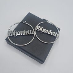 "Introducing our stunning Ghoulette 50mm diameter hoop earrings! Crafted from high-quality stainless steel, these earrings are both durable and stylish. The silver colour adds a touch of elegance to any outfit, making them perfect for both casual and formal occasions. We love everything Nameless Ghoul, Ghost and Papa Emeritus here at T.C.C And if you're looking for even more personalized options, be sure to check out our \"Custom Hoop Earrings\" listing. With bold Old English font, these earring Ghoul Ghost, Papa Emeritus, English Font, Old English Font, Ghost Bc, Silver Colour, Outfit Making, Jewelry Earrings Hoops, Favorite Jewelry