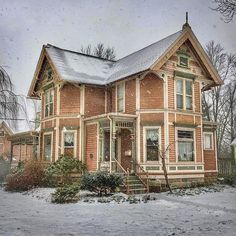 a red brick house with snow on the ground