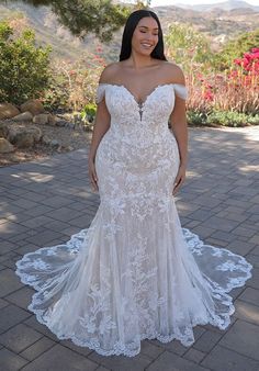 a woman in a white wedding dress posing for the camera