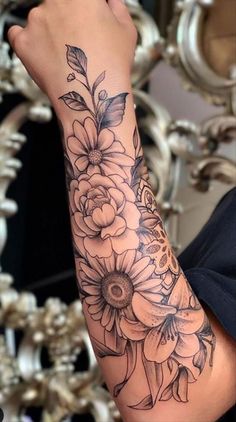 a woman's arm with flowers on it