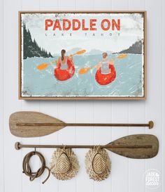 paddle on lake tahoe with two people in kayaks and oars hanging from the wall