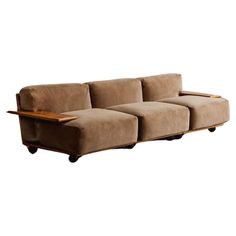 a brown couch sitting on top of a wooden table