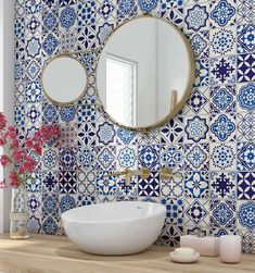 a bathroom with blue and white tiles on the wall