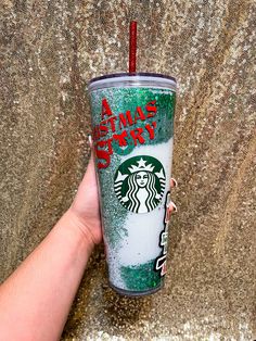 a hand holding a starbucks cup with the words christmas story written on it in red and green sprinkles