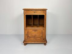 an old wooden cabinet sitting on top of a white floor