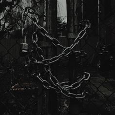 a chain link fence in front of an old building