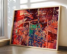 an abstract painting on the wall next to a window