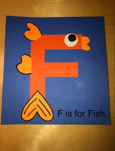 a letter f is for fish on a blue background with an orange fish in the middle