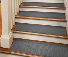 a set of stairs with carpet mats on them