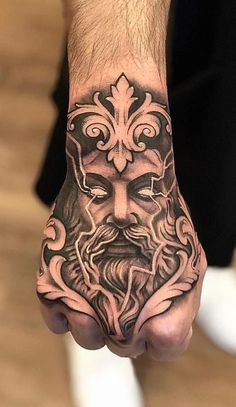 a man's hand with a tattoo on it