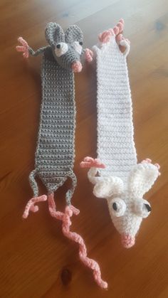 three crocheted animal headbands sitting on top of a wooden floor next to each other