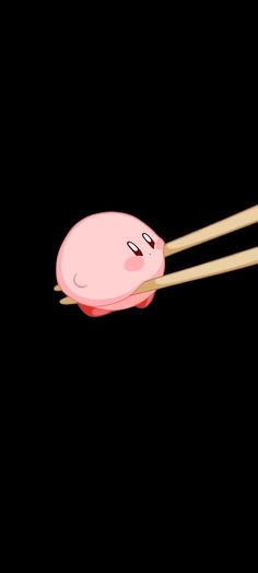 two chopsticks sticking out of a cartoon character's face on a black background