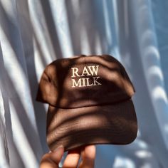 "Raw Milk Dad Hat Design If you know you know! One of the Natures greatest Blessing full of nutrients! If you love Raw Milk Represent with this super cool dad hat :) Select hat color Select thread color Raw Milk design - 2\" wide Example Shown: Khaki Dad Hat Red Thread Hat info I have unconstructed hats with two different buckle types, the gold buckle and the metal adjustable strap. Washed 100% Cotton Blank Baseball Cap  One size fits most Please see photos for which color has which strap. Pleas Cool Dad Hats, Milk Design, Red Thread, Hat Design, 2nd Anniversary, Embroidery Patches, Dad Hat, Kind Words, Hat Designs