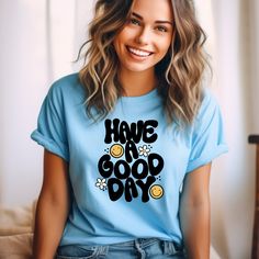 Spread joy and positivity wherever you go with our "Have a Good Day" unisex t-shirt! 🌼😊 Featuring cute bubbly text adorned with daisies and smiley faces, this tee is guaranteed to lift your spirits and brighten your day. Get ready to spread good vibes and smiles with every wear! 🌈 Happy Vibes: Embrace the power of positivity with our cheerful tee! The playful design and uplifting message are sure to put a smile on your face and the faces of those around you. It's like wearing a ray of sunshin Fun Slogan T-shirt For Everyday, Cute Everyday T-shirt With Slogan, Cute Slogan T-shirt For Everyday, Cute Everyday T-shirt With Letter Print, Inspirational Everyday T-shirt With Graphic Print, Smiley Daisy, Positive Tees, Smiley Faces, Power Of Positivity