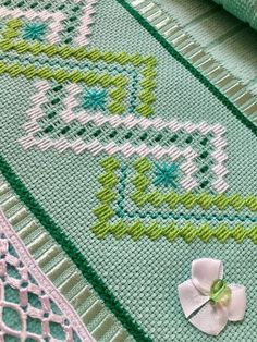 a close up of a cross stitch blanket