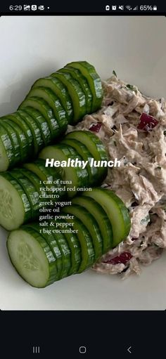 some cucumber slices are arranged in a bowl with the word healthy lunch on it