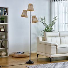 a living room with a white couch and two floor lamps