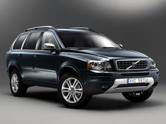 a black volvo suv is shown in this studio shot, with the front lights on