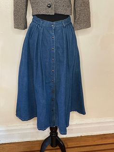 Delightful 1970'/80s Geoffrey Hunter button-up A line denim skirt. Vintage 1970's or early 80's 100% Cotton Made in the USA 28" Waist, 68" Middle, 92" Bottom Front Pockets (NOTE - Hole in one pocket) Very flared - see measurements Pleats Belt holes Super cute!! Retro Button-up Bottoms For Spring, Retro Denim Skirt For Fall, Medium Wash Button-up Cotton Skirt, Vintage Denim Skirt With Pockets For Spring, Vintage Denim Skirt For Fall, Vintage Cotton Skirt In Dark Wash, Vintage Denim Skirt For Spring, Vintage High Waist Denim Skirt For Spring, Vintage Wide Leg Denim Skirt