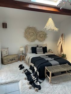 a bed room with a neatly made bed and two hanging baskets on the headboard