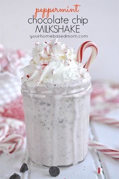 peppermint chocolate chip milkshake in a glass with candy canes