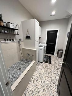 a bathroom with a sink, washer and dryer