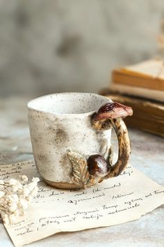 a coffee cup with two birds on it sitting on top of a piece of paper