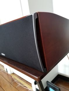 a large wooden speaker sitting on top of a table