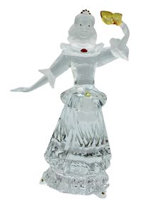 a glass figurine holding a butterfly in its right hand and wearing a white dress