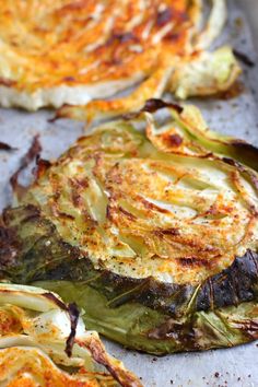 an artichoke dish on a baking sheet with other food items in the background