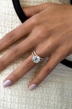 a woman's hand with a ring on her finger