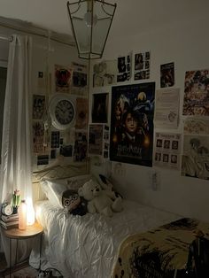 a bedroom with posters on the wall and a bed