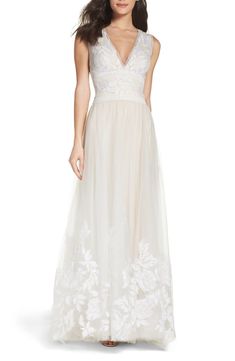 Tadashi Shoji Tulle Lace A-Line Gown - Softly voluminous tulle embellished with ornate embroidery underpins the romantic style of this classically feminine wedding gown tailored with a sharply descending neckline.  Hidden back-zip closure. Deep V-neck. Sleeveless. Flowing A-line skirt.  #wedding #weddingdress #vneck #aline #tulle  *This is an affiliate link. Petite Bride, Petite Wedding Dress, Feminine Wedding, Affordable Wedding Dresses, Tadashi Shoji, A Line Gown, Tulle Lace, Lace Gown