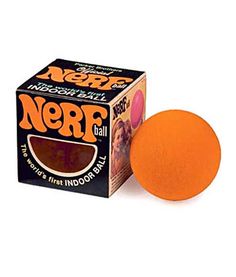 an orange ball sitting next to a box of nerf balls on a white background