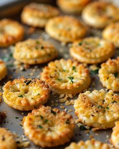 small appetizers are sitting on a baking sheet with parmesan sprinkles