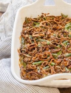 a casserole dish filled with green beans and onions