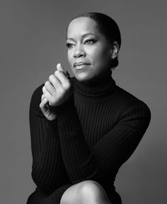 a black and white photo of a woman sitting down