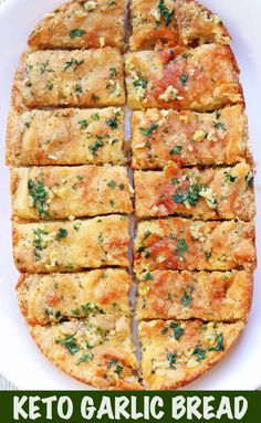 keto garlic bread cut into squares on a white plate with the title above it