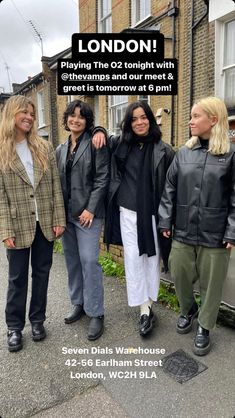 three women standing next to each other in front of a building with the words london on it