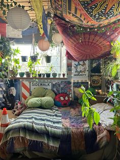 a bed room with a neatly made bed and lots of plants